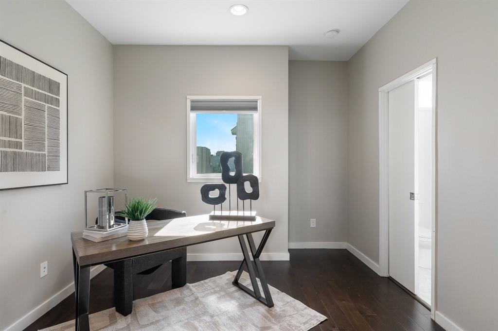 Interior room featuring dark wood-finish flooring, recessed ceiling lighting, and a sliding pocket door
