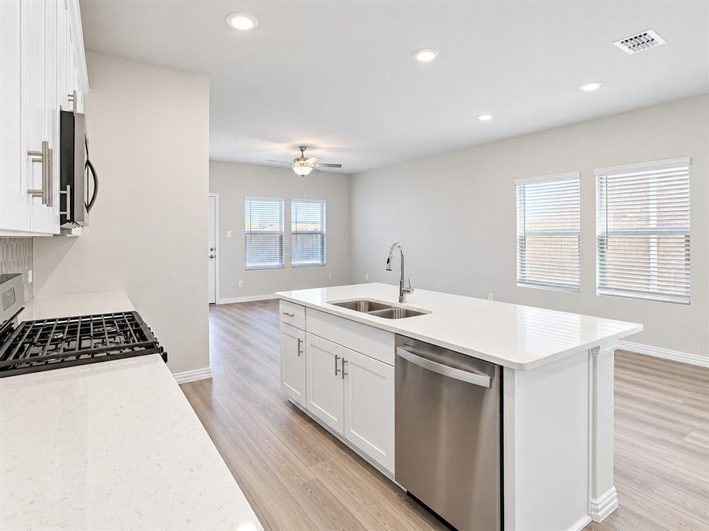 Kitchen island with a double basin sink and stainless steel dishwasher