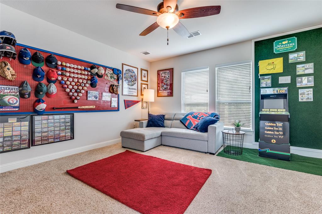 Room featuring carpeting, dual windows with horizontal blinds, and a ceiling fan with integrated lighting