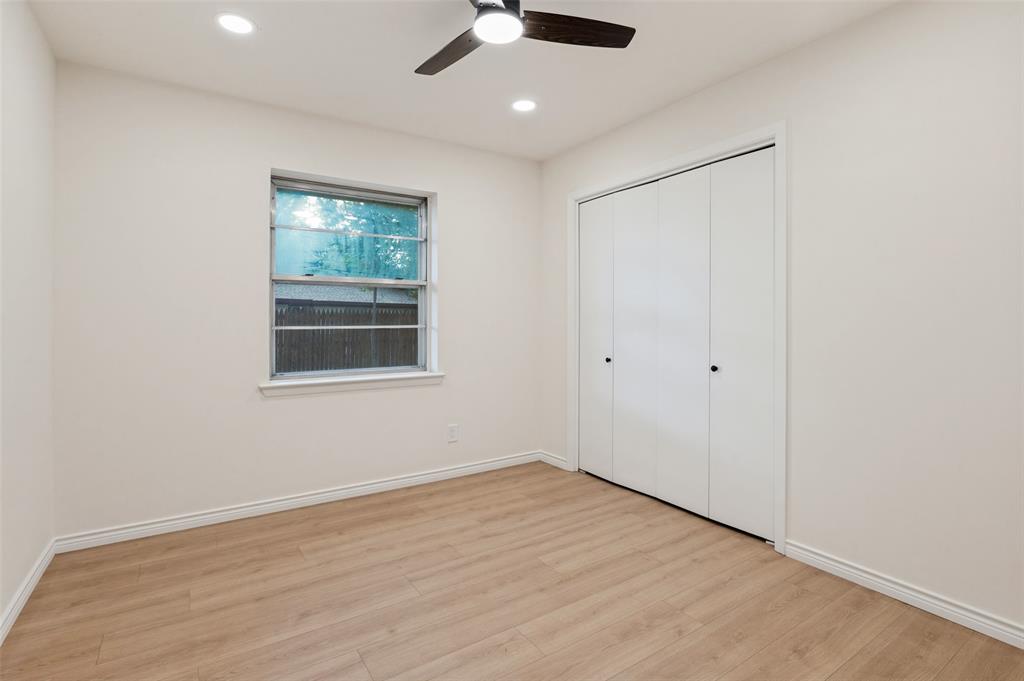 Interior space featuring wood-finish flooring, recessed lighting, a ceiling fan, and a built-in closet with folding doors