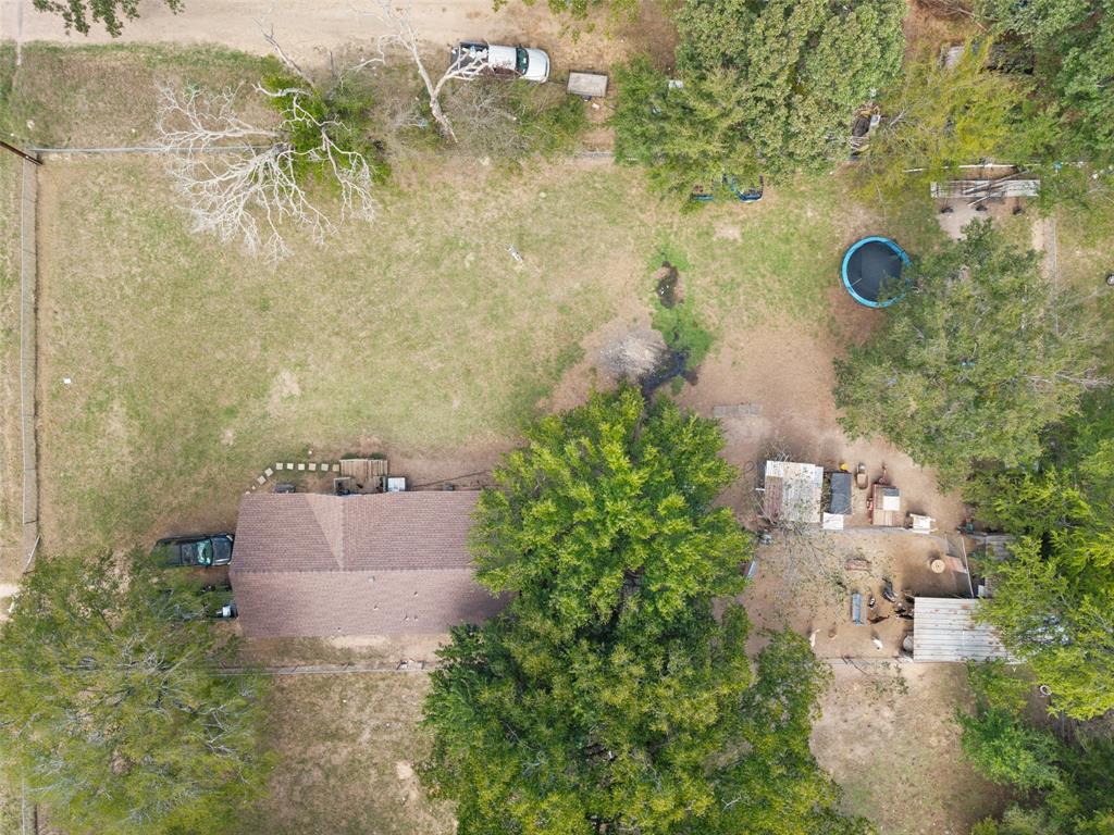 Expansive lot featuring mature trees, perimeter fencing, and established vegetation