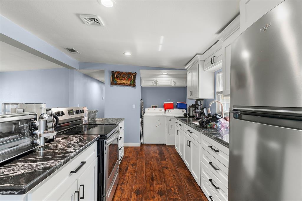 Kitchen featuring white shaker-style cabinetry, high-contrast patterned countertops, wood-finish flooring, stainless steel appliances, and recessed lighting