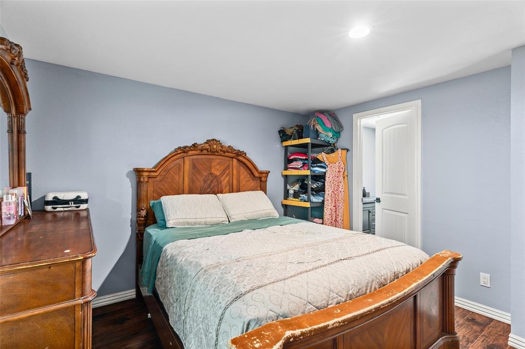 Room featuring wood-finish flooring, recessed lighting, and a six-panel interior door