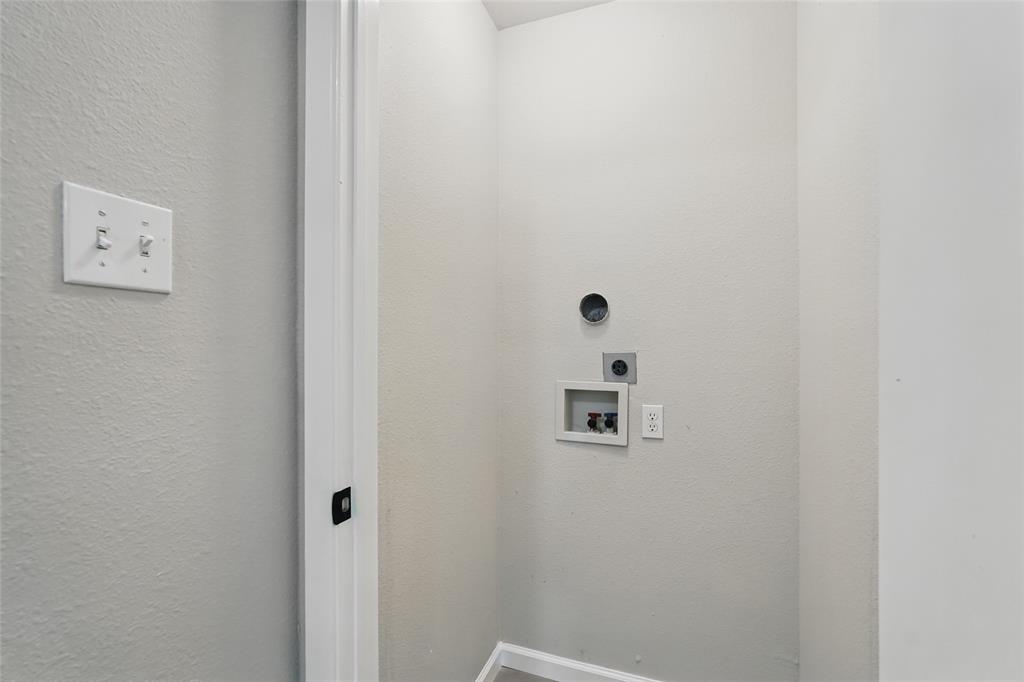 Utility area featuring laundry hookups, dedicated ventilation, and dual toggle light switches