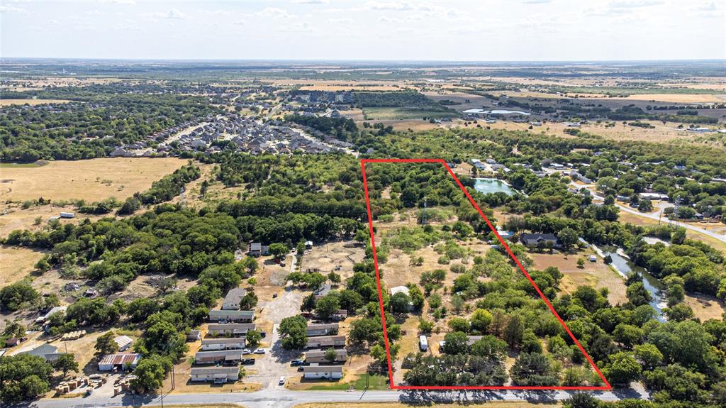 Large, expansive lot featuring mature trees, native vegetation, and direct frontage on a local thoroughfare