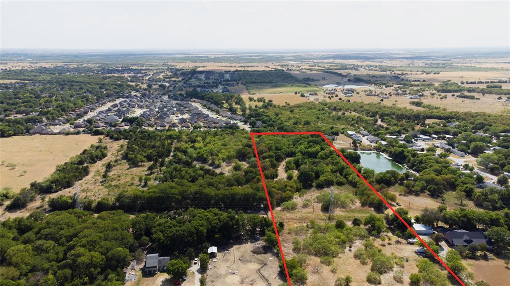 Expansive acreage featuring mature trees, natural vegetation, and a private pond