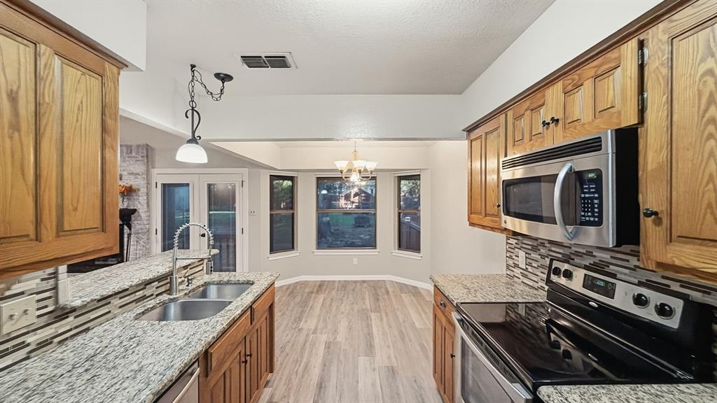 Full kitchen view looking out to breakfast area