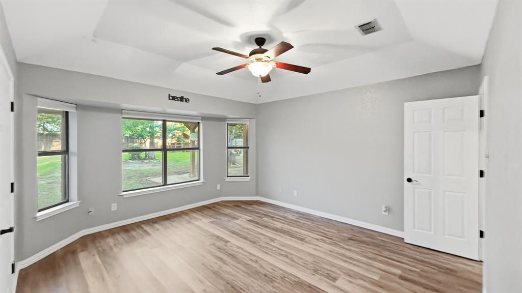 Another view of primary bedroom and windows