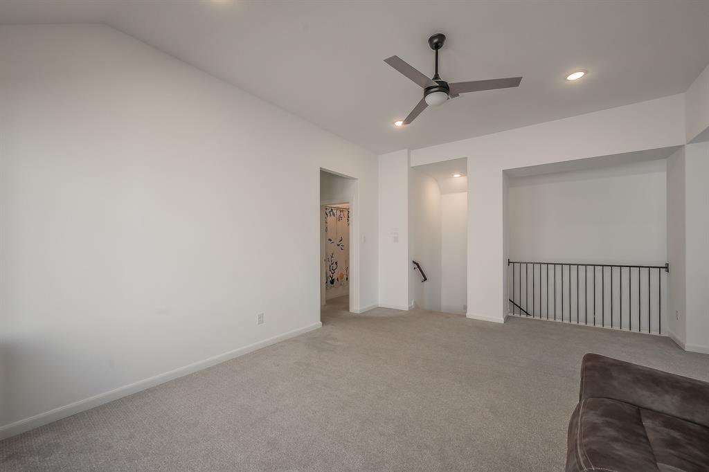 Metal baluster over the stairs, separate from living room downstairs, perfect as a secondary media room, game room, or other