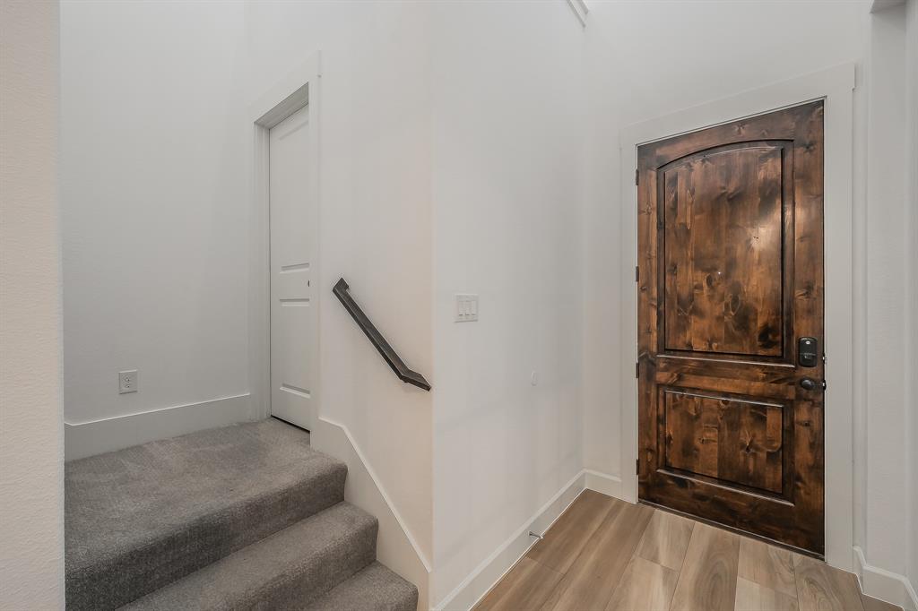 Stairs to second floor with powder room for guests