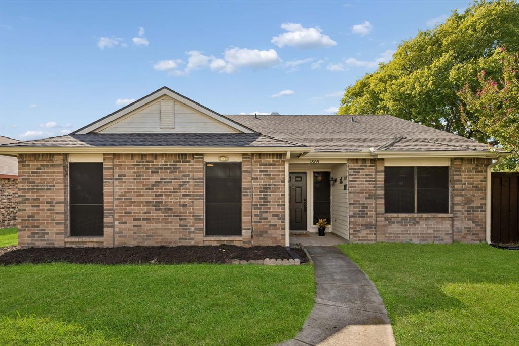 Single-story brick exterior featuring a hip roof, gabled facade detail, and a front walkway leading to a recessed entry. Single-story brick exterior featuring a hip roof, gabled facade detail, and a front walkway leading to a recessed entry.