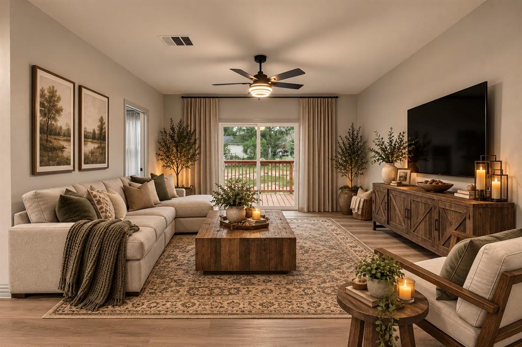 AI INSPIRED -- Living area featuring wood-finish flooring, a central ceiling fan with integrated lighting, and a sliding glass door providing external access