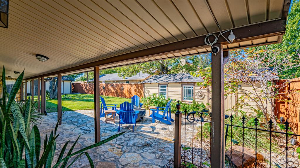Flagstone patio area in side yard. Vinyl facia for low maintenance