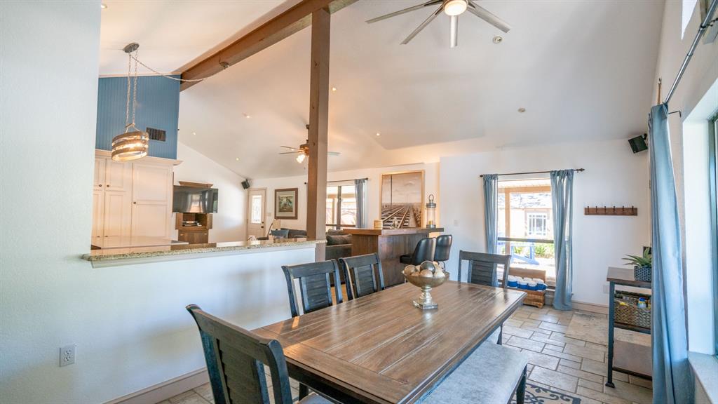 Spacious dining area with tile flooring and lots of natural light and access to the back patio