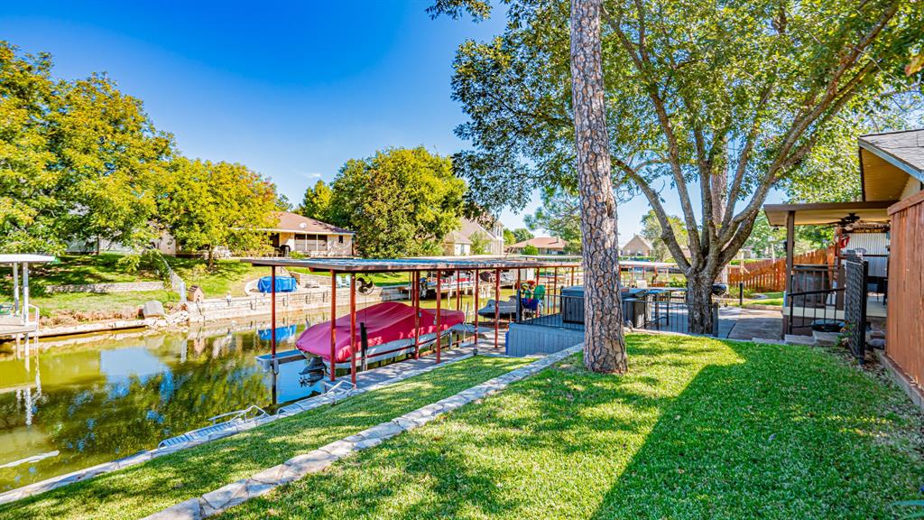 Boat dock with a lift and a double Sea Doo lift. Flagstone walkway to boat dock. Large jacuzzi hot tub on the Trex deck
