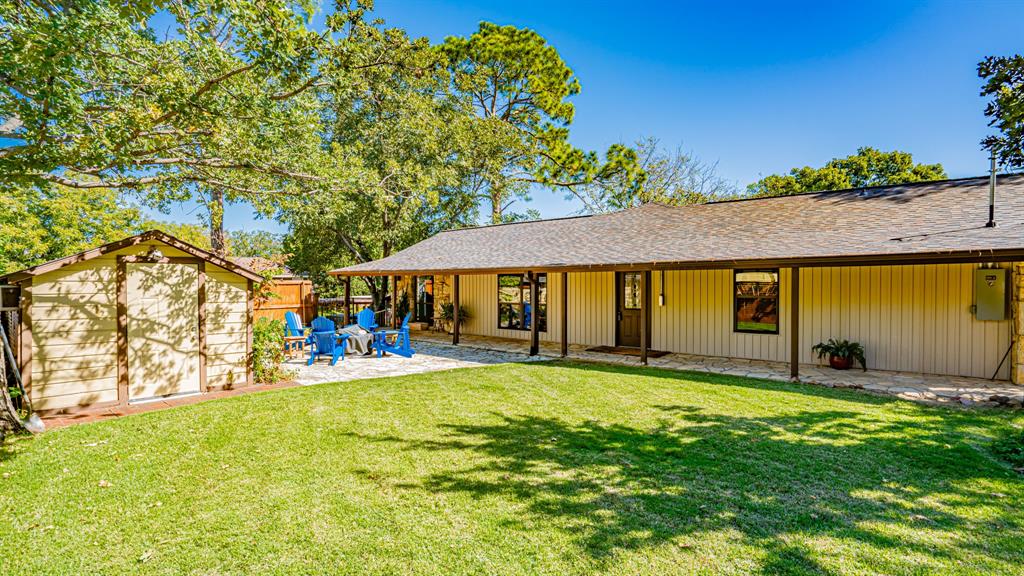 Covered patio along house with large yard and storage building. Flagstone patio recentlly added with firepit for winter lounging.