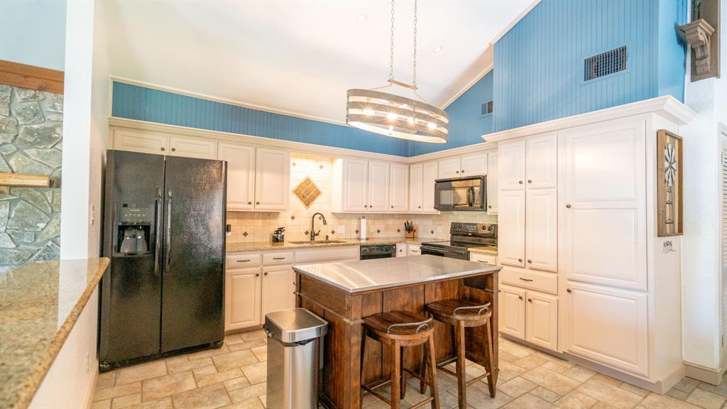 Kitchen with new stainless topped island seating and lots of cabinet space