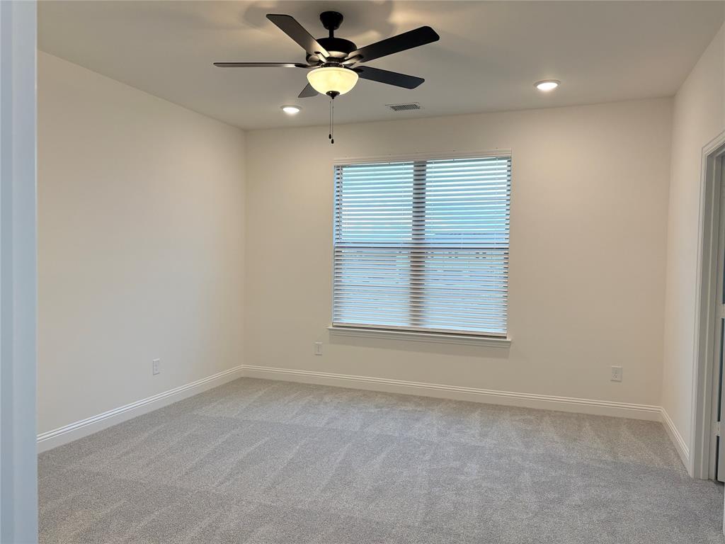 Neutral-toned carpeting, matte black ceiling fan with integrated lighting, recessed lighting, and horizontal window blinds