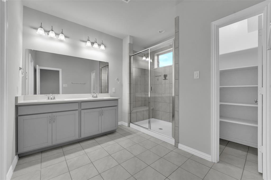 Dual vanity with undermount sinks and light-colored countertops