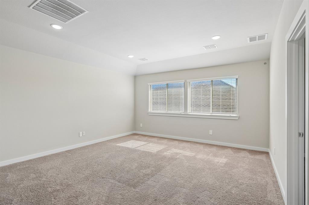 Tray ceiling, neutral wall tones, recessed lighting, and wall-to-wall carpeting