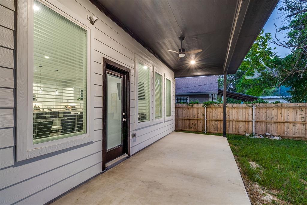Covered back patio with a concrete floor, horizontal lap siding, integrated ceiling fan, and access via a full-lite exterior door