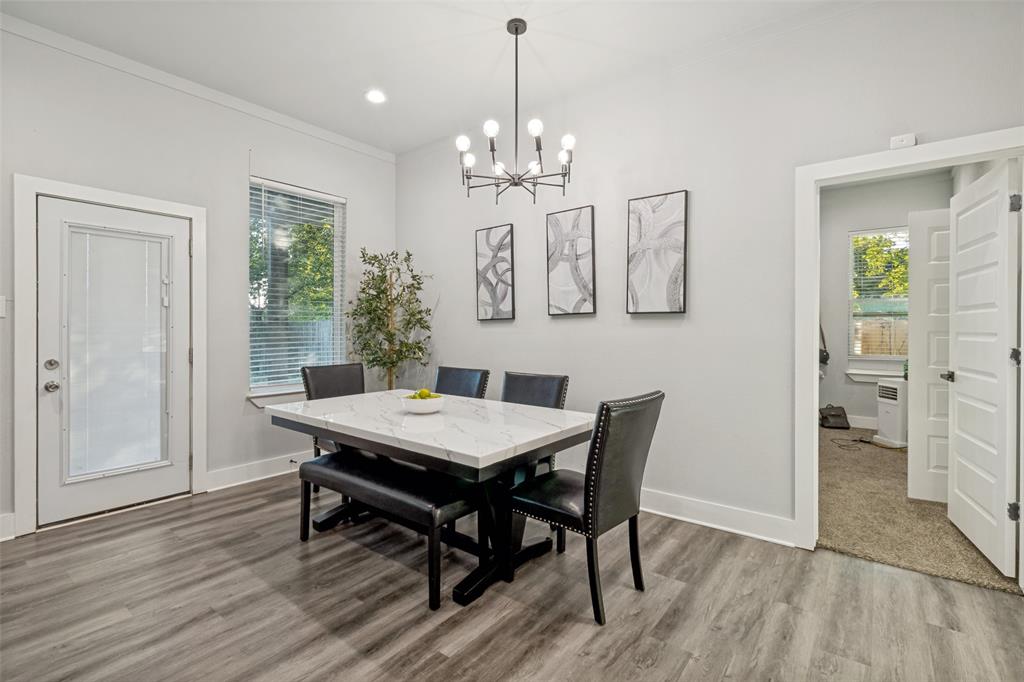 Room featuring wood-finish flooring, a multi-arm chandelier, recessed lighting, and a door with an inset glass pane