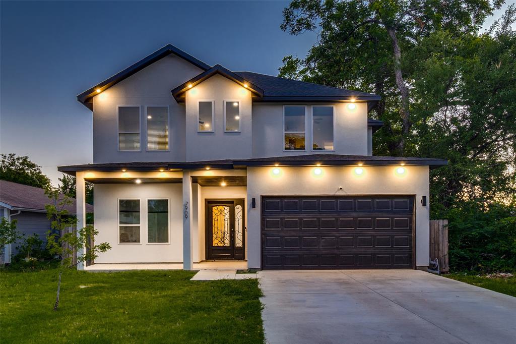 Two-story stucco exterior featuring a covered front porch, an ornamental glass-paneled entry door, a multi-car garage, and double-hung windows