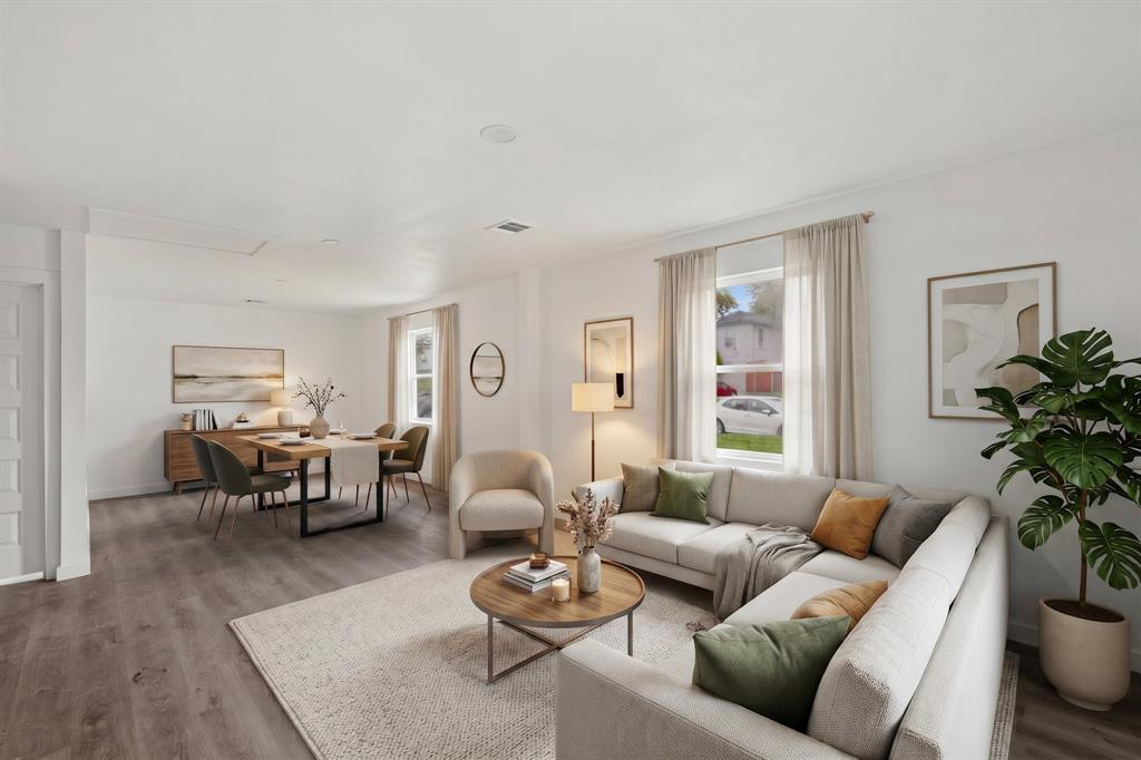 Open-concept interior featuring wood-finish flooring, neutral wall tones, and recessed lighting