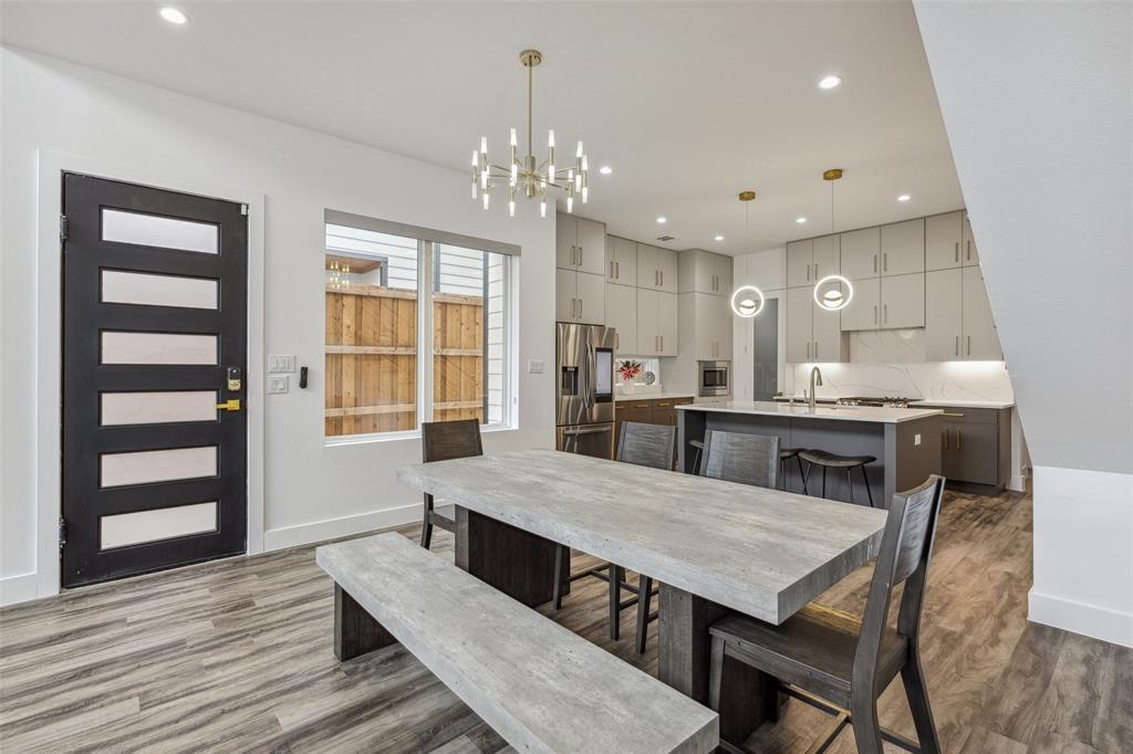 Dining room featuring hardwood / wood-style flooring, sink, and an inviting chandelier