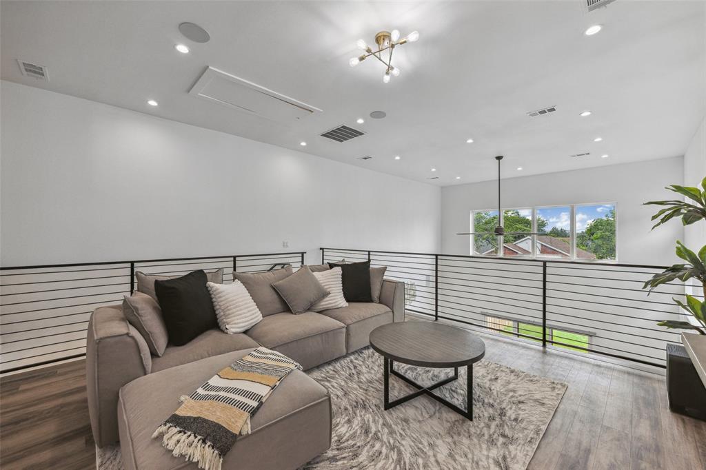 Living room with hardwood / wood-style floors and a chandelier