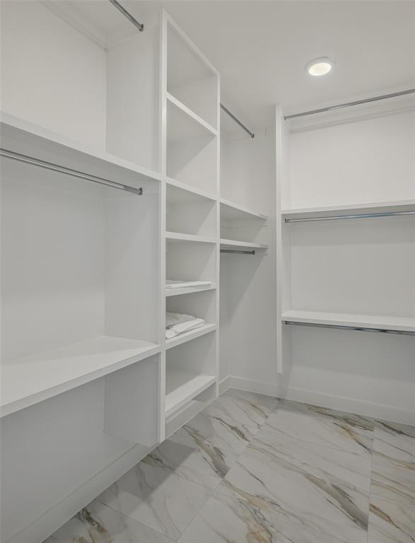 Spacious closet featuring light tile patterned flooring