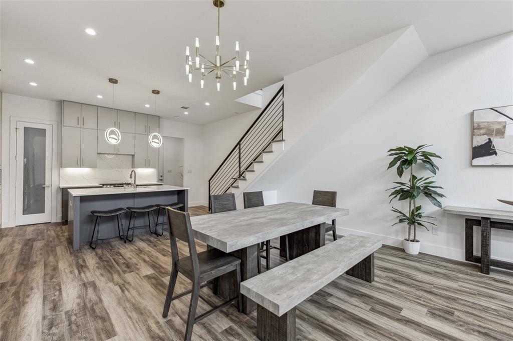 Dining room with hardwood / wood-style flooring, sink, and a chandelier