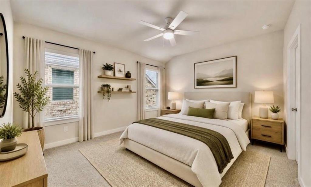 Neutral-toned bedroom featuring vaulted ceilings, a central ceiling fan with integrated lighting, dual windows, and wall-mounted shelving