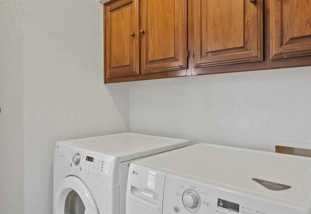 Wall-mounted wood cabinetry featuring recessed-panel doors and round hardware