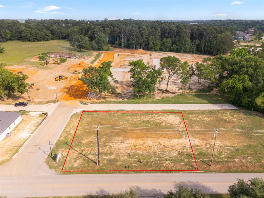 Aerial view of property's location featuring property boundaries highlighted and a forest