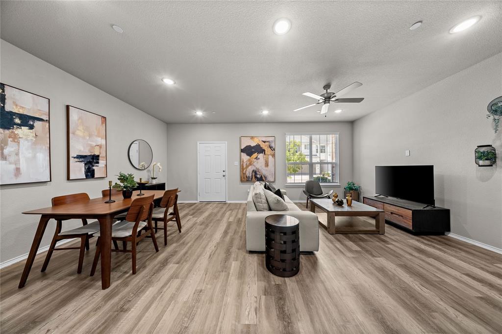Open-concept interior featuring wood-finish flooring, recessed lighting, and a ceiling fan