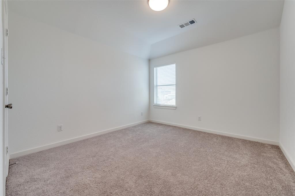 Empty room featuring light carpet and baseboards