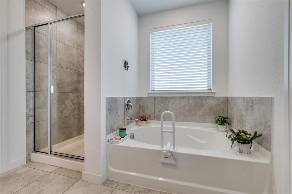 Full bath with a shower stall, a garden tub, and tile patterned flooring