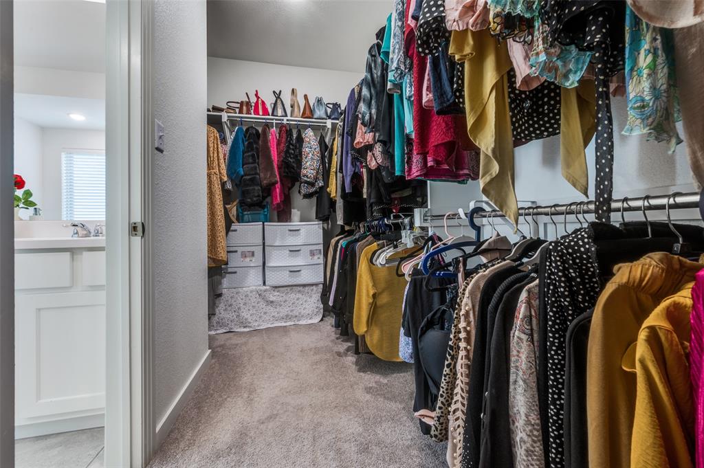 Spacious closet with light colored carpet