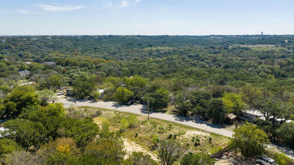 Aerial perspective featuring expansive topography, mature tree canopy, and established greenery