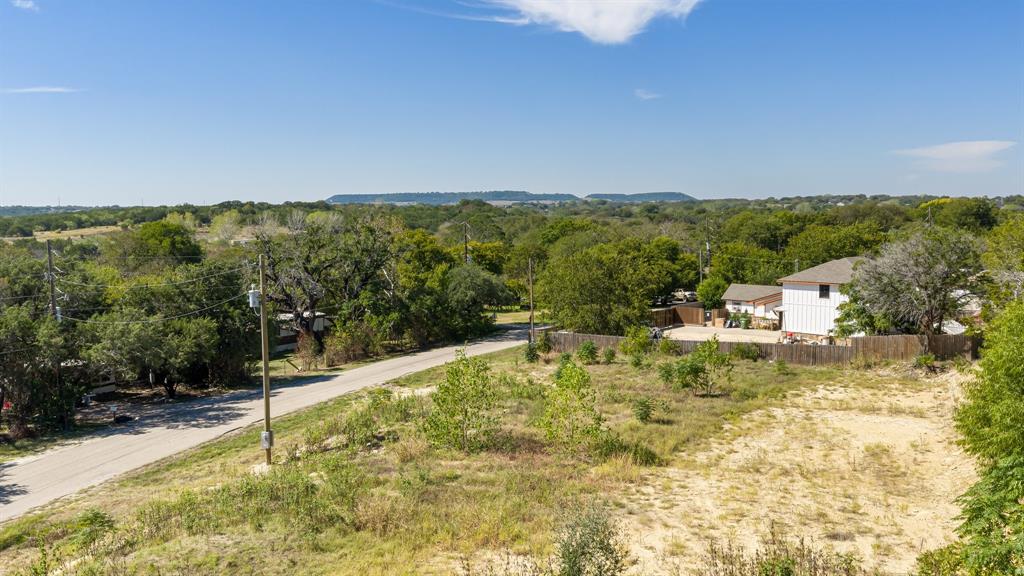 Expansive parcel featuring mature trees, natural vegetation, and open topography with distant mesa formations