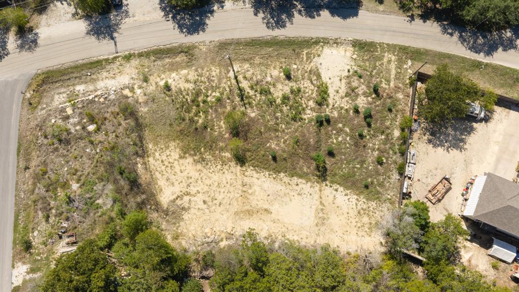 Corner lot featuring natural terrain, mature trees, and street access on two sides