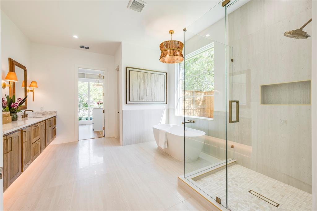 Floating white oak fluted double vanity, 72" soaking tub, oversized shower and Brizo faucets