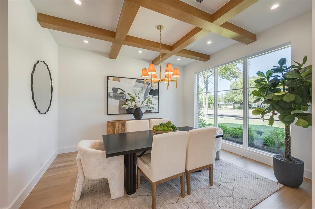 Light-filled dining room with white oak coffered ceiling and designer chandelier