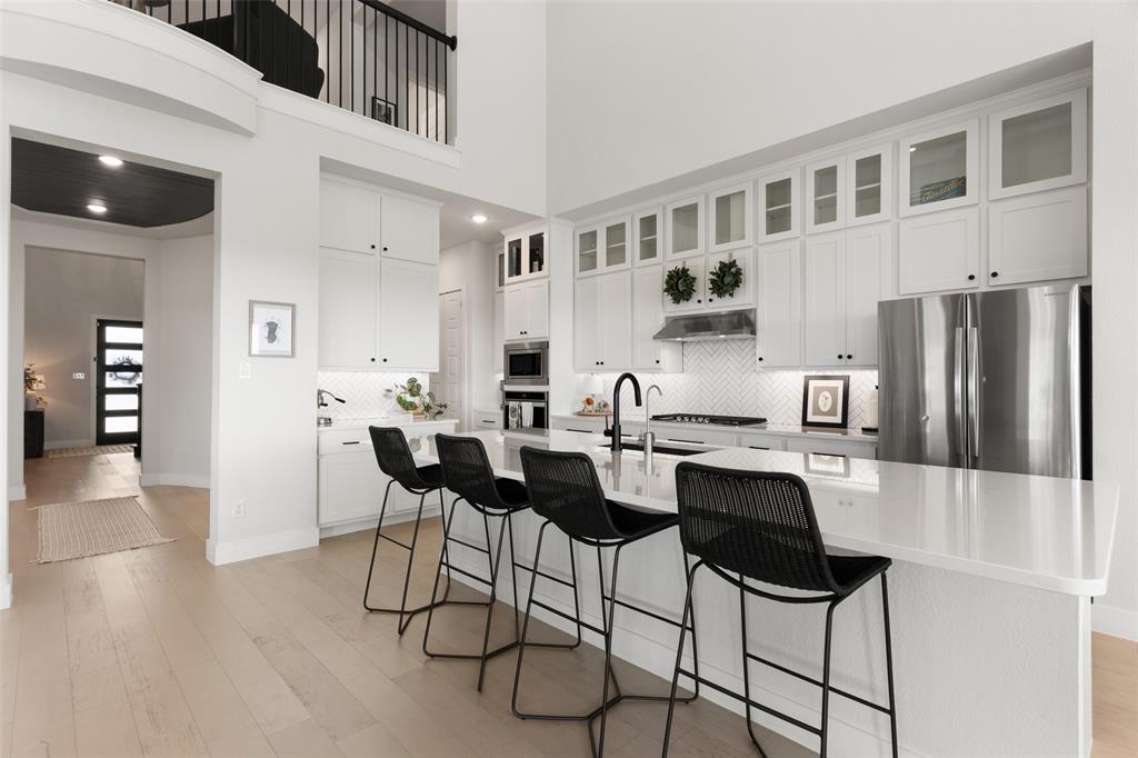 Beautifully appointed Kitchen w quartz countertops, stacked cabinetry, and more!