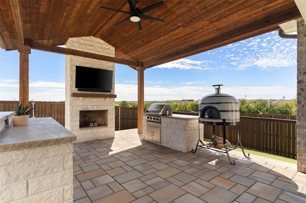 Outdoor Living w wood-burning fireplace and outdoor kitchen!