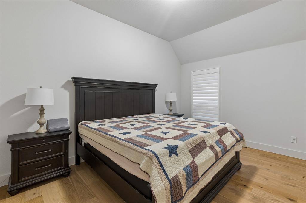 Vaulted ceiling featuring wood-finish flooring and shuttered windows Vaulted ceiling featuring wood-finish flooring and shuttered windows