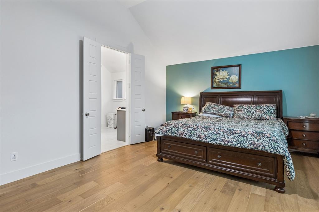 Vaulted ceilings, wood-finish flooring, and double doors