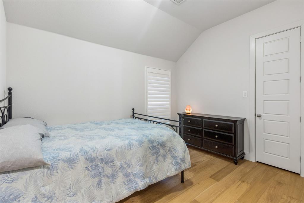 Vaulted ceilings, wood-finish flooring, and white plantation shutters Vaulted ceilings, wood-finish flooring, and white plantation shutters
