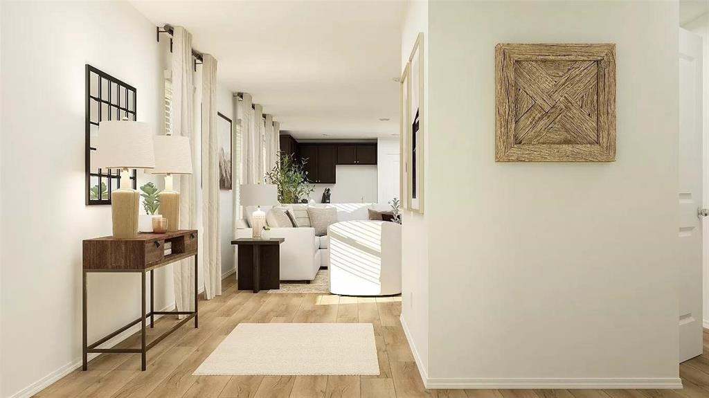 Neutral-toned walls paired with continuous wood-finish flooring throughout the interior Neutral-toned walls paired with continuous wood-finish flooring throughout the interior